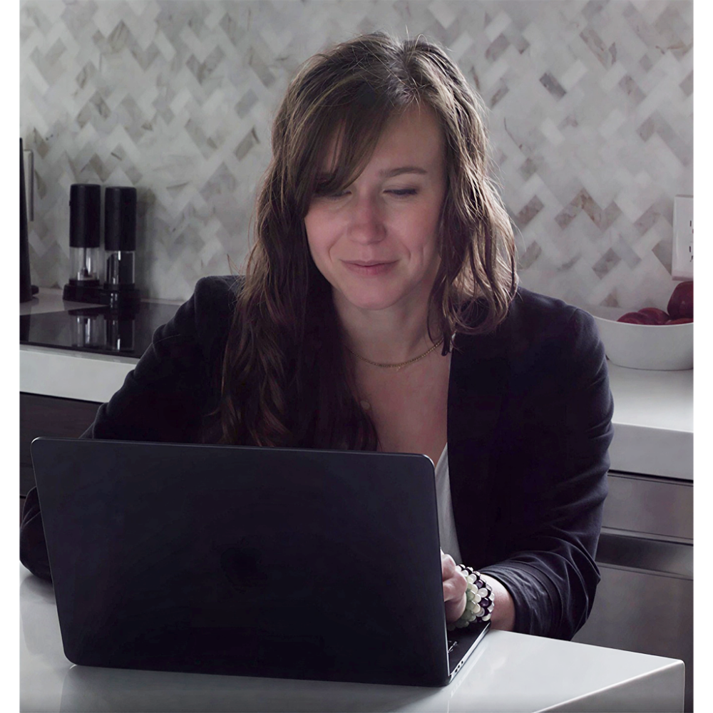 Amy reviewing a website at her laptop